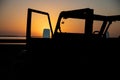 Silhouette of a car against a sunset in a beach Royalty Free Stock Photo