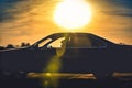 The silhouette of the car moves with the background light and sunset.This image is motion blur. Royalty Free Stock Photo