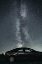 Silhouette of Car under beautiful night sky with stars and amazing Milky way galaxy