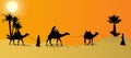 Silhouette of Caravan mit people and camels wandering through the deserts