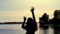 Silhouette of the carefree woman dancing at the beach during beautiful sunrise. vacation vitality healthy living concept Royalty Free Stock Photo