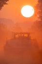 Silhouette of a cargo boat in the fiery red fog on a misty Morning on the River during sunrise Royalty Free Stock Photo