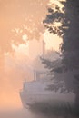 Silhouette of a cargo boat in the fiery red fog on a misty Morning on the River during sunrise Royalty Free Stock Photo