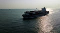 silhouette cargo container ship sailing in sea to import export goods and distributing products to dealer and consumers worldwide