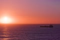 Silhouette of the cargo ship over the sunrise. Royalty Free Stock Photo