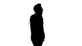 Silhouette Casual man talking on mobile phone while walking. Royalty Free Stock Photo