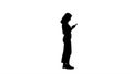 Silhouette Casual young woman typing on mobile phone. Royalty Free Stock Photo