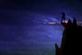 Silhouette of a champion man and the Universe.A person is standing on the top of the hill next to the Milky Way galaxy with