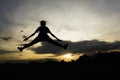 Silhouette of cheerful positive and full energy girl jumping in the air for life energy concept