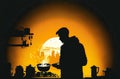 silhouette of a person cooking on a gas stove with the pan in the foreground (AI Generated)