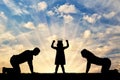 Silhouette of a child girl with a crown on her head and parents worshiping her