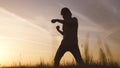 silhouette child kid boxer. boy a boxing with shadow exercising at sunset outdoor. kid dream. sport victory healthy