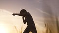 silhouette child kid boxer. boy a boxing with shadow exercising at sunset outdoor. kid dream. sport victory healthy Royalty Free Stock Photo