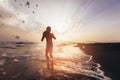 Silhouette of child playing with ball during sunset. Royalty Free Stock Photo