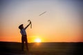 Silhouette of child playing with bow and arrows, archery shoots a bow at the target