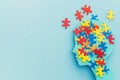 Silhouette of child's head with colorful puzzles on background, autism awareness concept