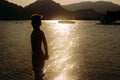 The silhouette of a child of the sea at sunset Royalty Free Stock Photo