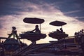 Silhouette of children enjoying the ride on a plane carousel in a fairground in Rovigo at sunset Royalty Free Stock Photo