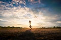 Silhouette of children flying a kite on sunset