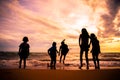 Silhouette children group enjoy playing on beach