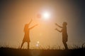 Silhouette children playing football on the sky sunset. Time on Royalty Free Stock Photo