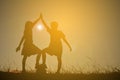 Silhouette children playing football on the sky sunset. Time on Royalty Free Stock Photo