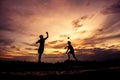 Silhouette of children playing paper airplane at sunset Royalty Free Stock Photo