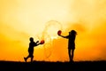 Silhouette of children playing water during sky sunset Royalty Free Stock Photo