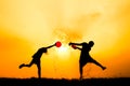 Silhouette of children playing water during sky sunset Royalty Free Stock Photo