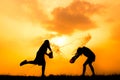 Silhouette of children playing water during sky sunset Royalty Free Stock Photo