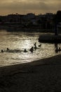 Silhouette of children playing in water at Sunset in Greece. Royalty Free Stock Photo