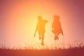 Silhouette children rope jumping on the sky sunset. Time on holiday happy and fun