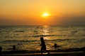 silhouette children run on beach and sunset