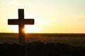 Silhouette of Christian cross outdoors at sunrise, space for text. Religion