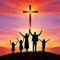 Silhouette of Christian family with cross on the sunset background. Royalty Free Stock Photo