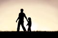 Silhouette of Christian Father Guiding his Young Child by the Hand