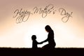 Mother Sitting Holding Hands with Young Child Outside at Sunset Royalty Free Stock Photo