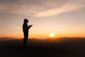 Silhouette of Christian woman praying worship at sunset. Christian Religion concept background. Hands  in prayer. worship god with Royalty Free Stock Photo