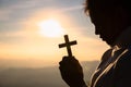 Silhouette of christian young women praying with a cross at sunrise, Christian Religion concept background