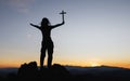 Silhouette of christian young woman praying with a  cross at sunrise, Christian Religion concept background Royalty Free Stock Photo