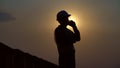 Silhouette Civil engineer inspection building and calling on site