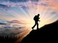 Silhouette climber ascending to the top of the mountain