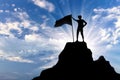 Silhouette of a climber with a flag on top of a mountain. Royalty Free Stock Photo