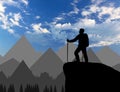 Silhouette of a climber on top looks into the distance over the mountains