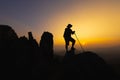 Silhouette of a Climber at the top of the rocky mountain at sunset, Man on top of mountain. Conceptual design. alone at the summit Royalty Free Stock Photo