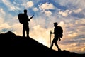 Silhouette climbers ascending the mountain