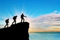 Silhouette climbers ascending to top of mountain Royalty Free Stock Photo