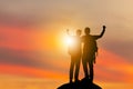 Silhouette of climbers man, hikers team celebration success happiness on a mountain top evening sky sunset / sunrise Background, Royalty Free Stock Photo