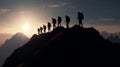 Silhouette of climbers who climbed to top of mountain thanks to mutual assistance and teamwork Royalty Free Stock Photo