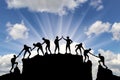 Silhouette of climbers who climbed to the top of the mountain thanks to mutual assistance Royalty Free Stock Photo